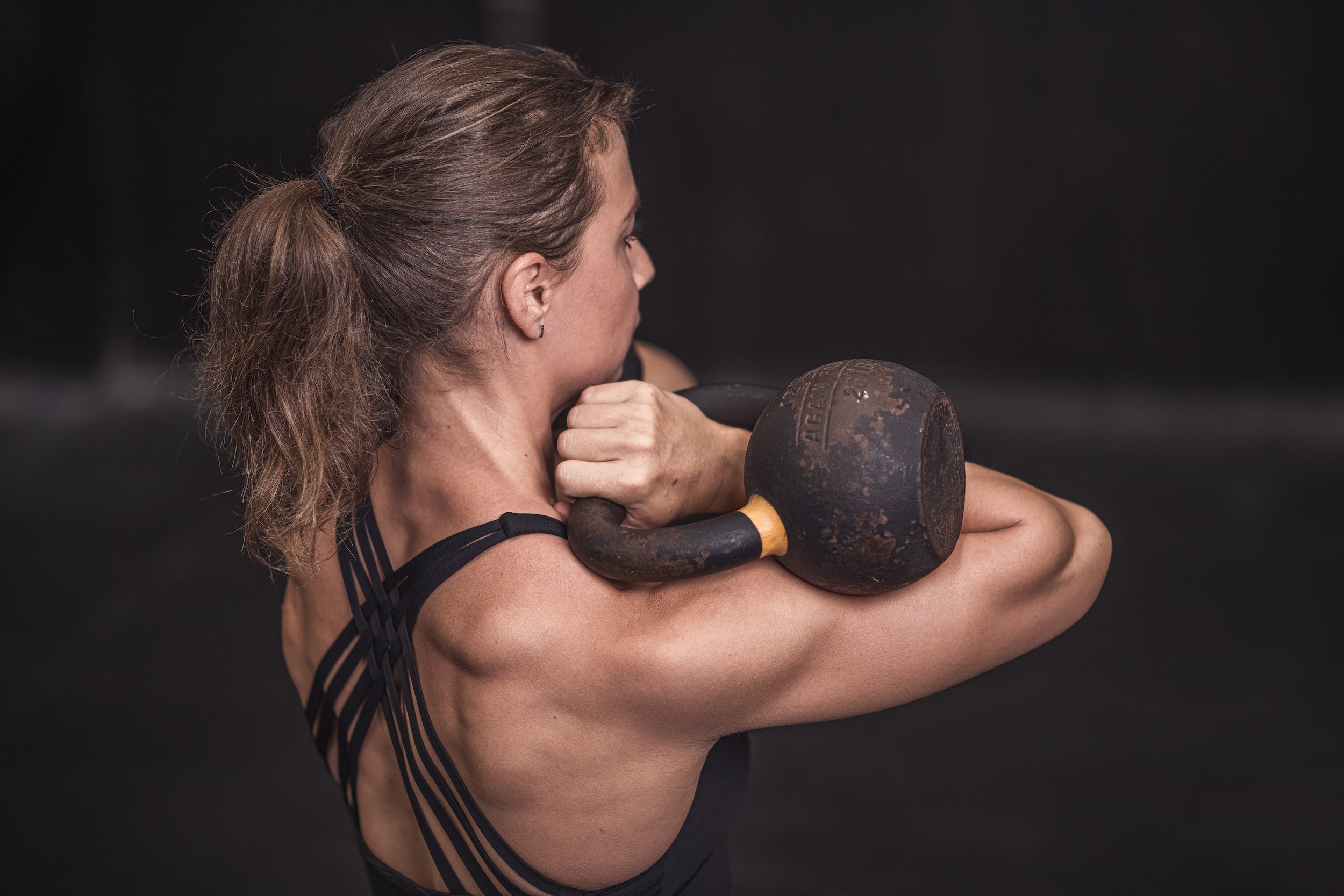 Woman training with kettlebells