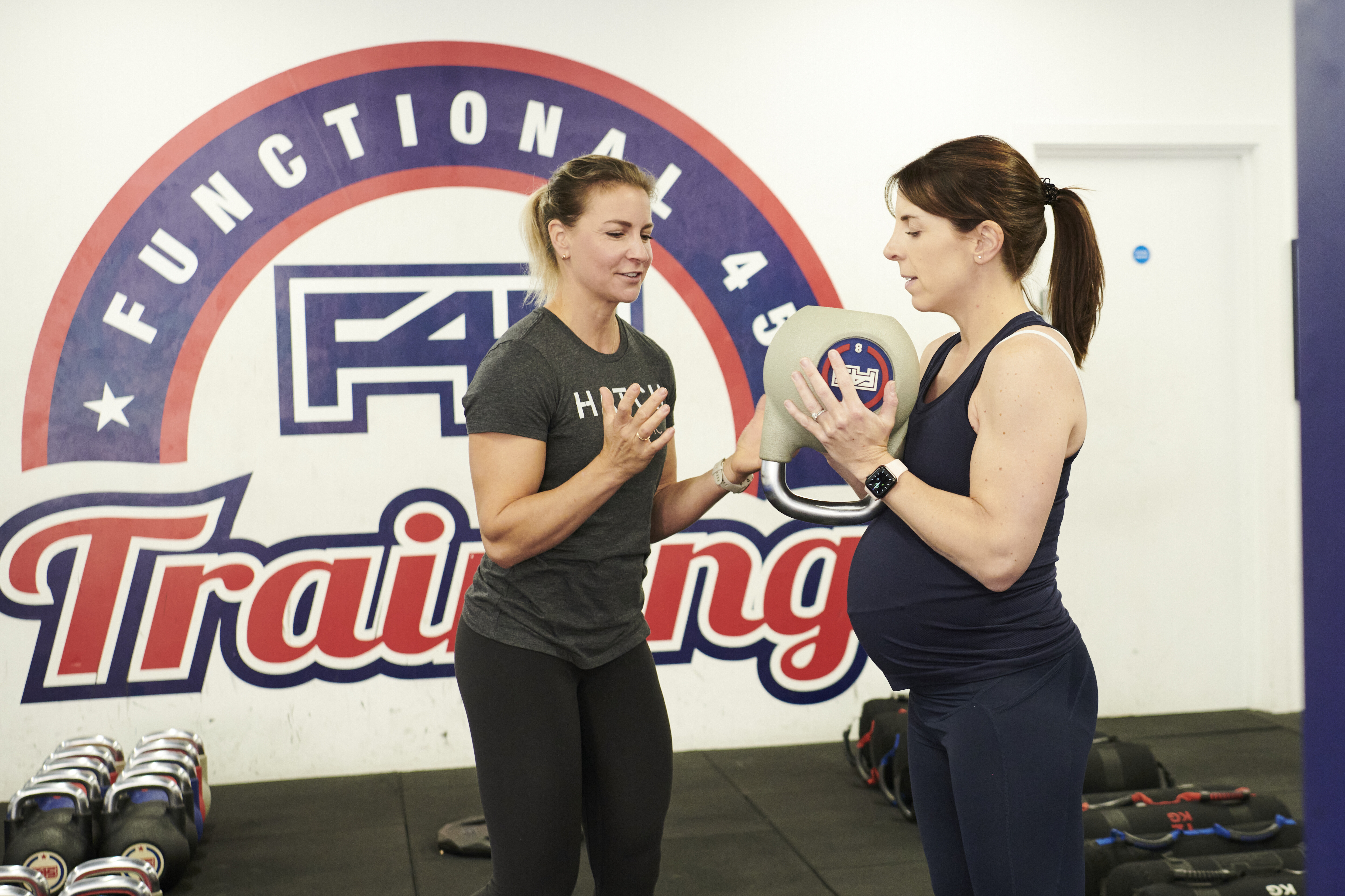 F45 coach working with a pregnant athlete