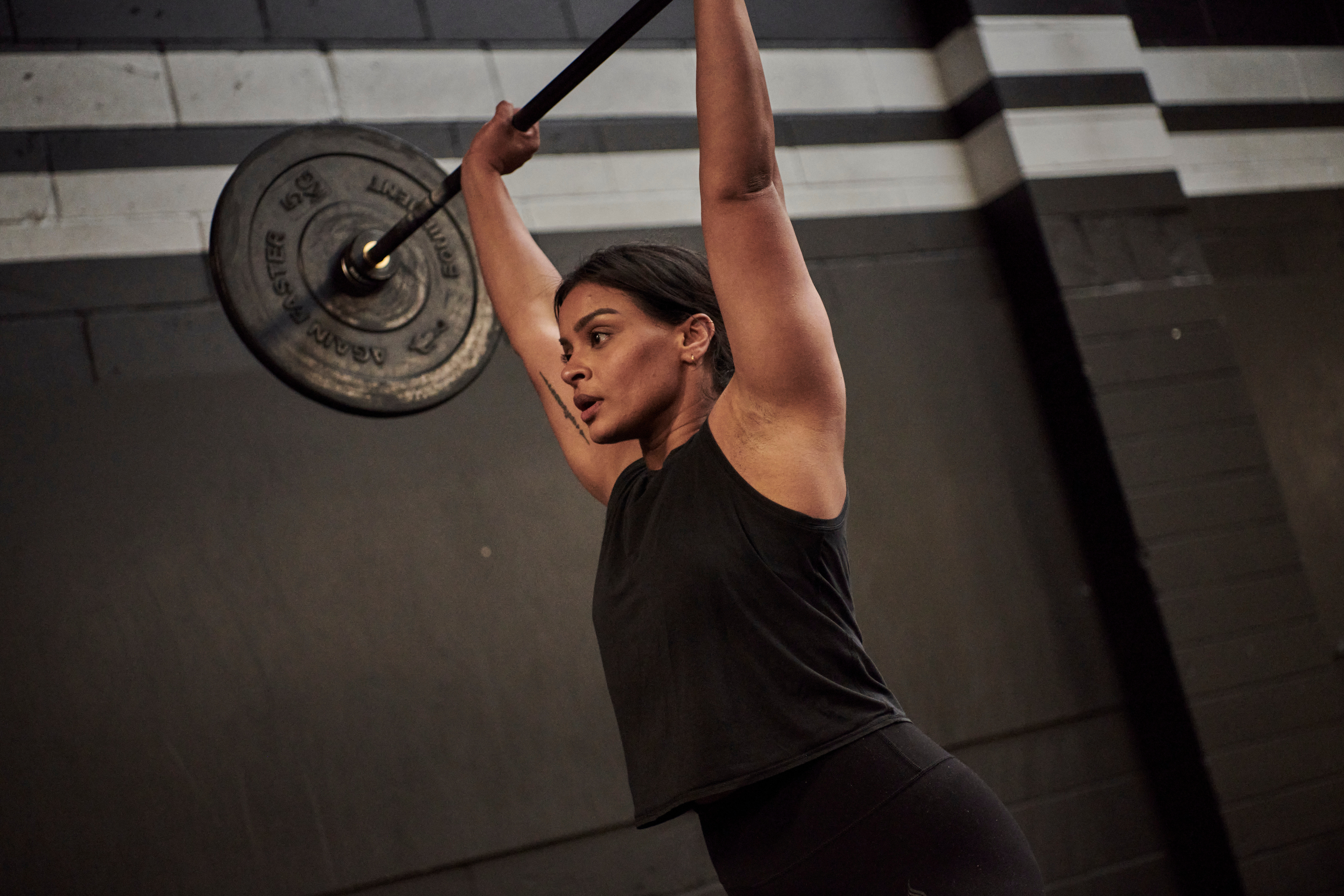 Woman lifting a barbell above her head