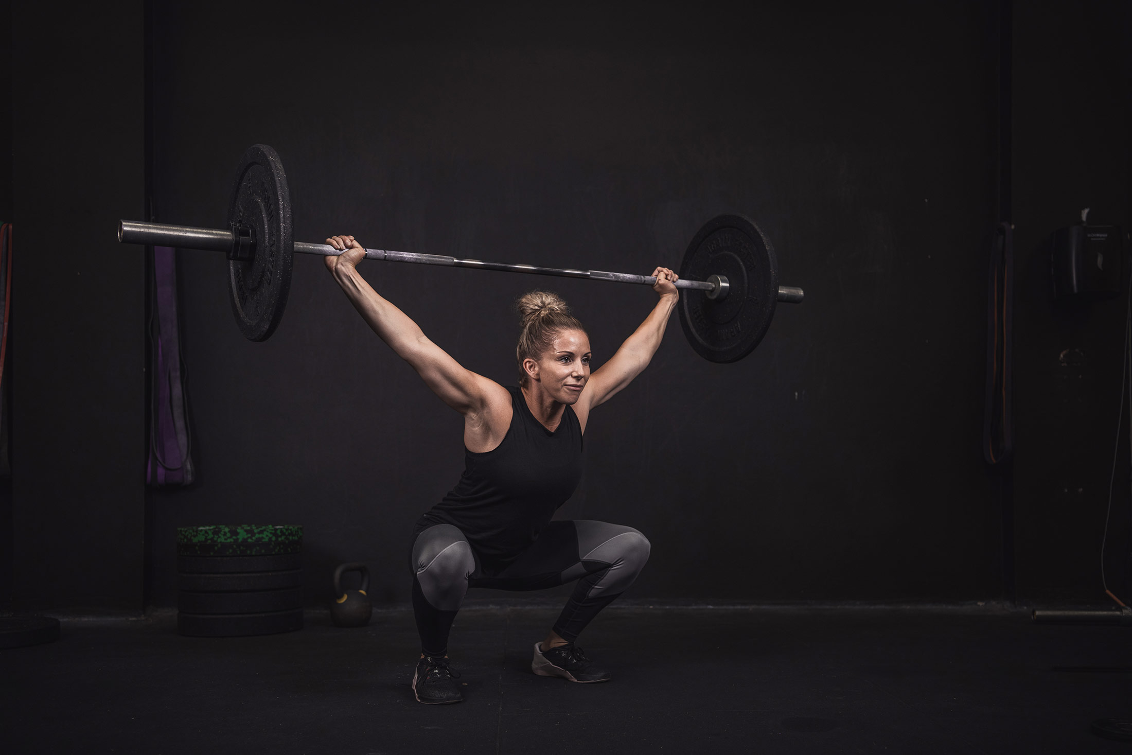 Woman snatching a barbell